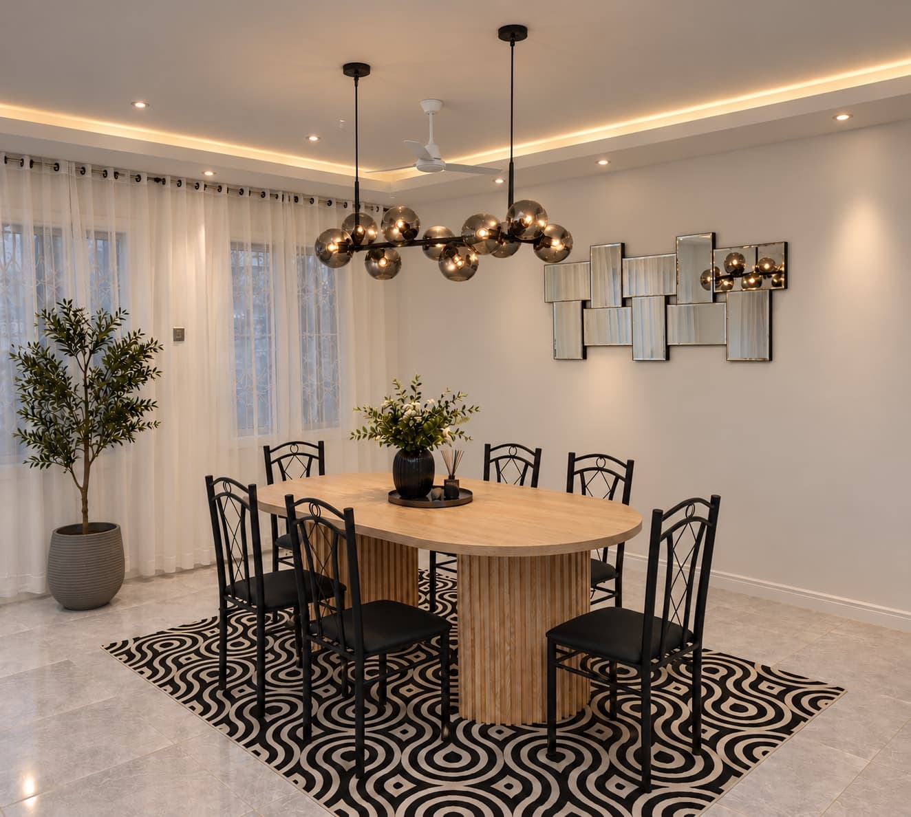 A dining room with an oval timber dining table, black chairs, a smoked-glass globe chandelier and a patterned rug